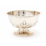 An Arts & Crafts silver circular rose bowl, plain body chased with stylised trefoil strapwork