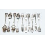 A set of four George III silver Fiddle pattern dessert spoons, each handle engraved with a crest, by