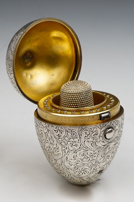 A late Victorian novelty silver egg shaped etui opening to reveal gilt metal interior fitted for