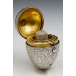 A late Victorian novelty silver egg shaped etui opening to reveal gilt metal interior fitted for