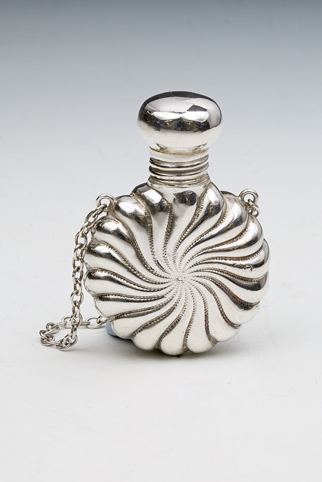 A Victorian small silver circular perfume bottle, radial wyvern fluted, on suspension ring, London