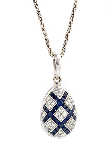 Faberge, an 18ct white gold, diamond, sapphire and enamel egg pendant, set with round brilliant-