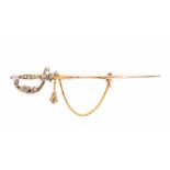 A Victorian diamond set jabot pin in the form of a sword, the scroll hilt decorated with rose cut