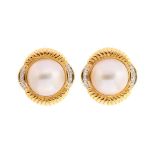 A pair of Mabe pearl earrings, the pearls measuring approx 14mm, with a fancy 18ct gold shell