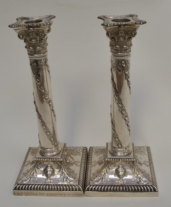 A pair of Edwardian silver candlesticks, detachable sconces above Corinthian capitals above