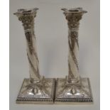 A pair of Edwardian silver candlesticks, detachable sconces above Corinthian capitals above