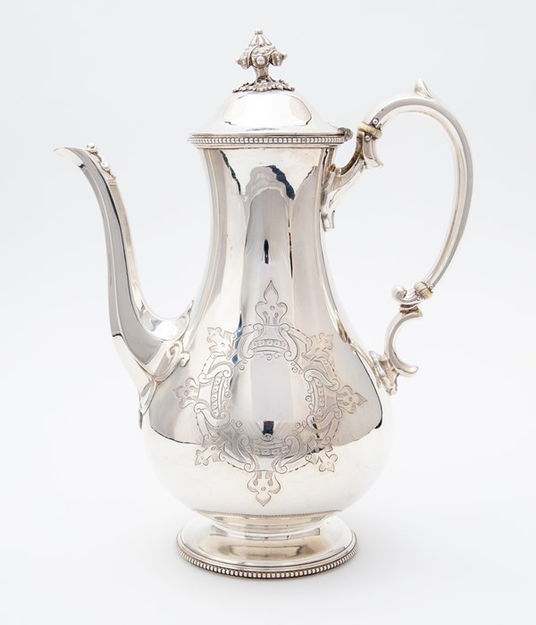 A Victorian silver pear shaped coffee pot, S-scroll ornate handle, the domed cover with stylised