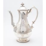 A Victorian silver pear shaped coffee pot, S-scroll ornate handle, the domed cover with stylised