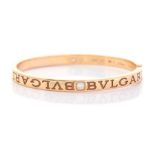 A Bvlgari diamond two-stone set 18ct yellow gold hinged bangle, two round brilliant cut diamonds