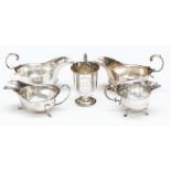 A pair of George V silver oval sauceboats, wavy rim on three hoof feet, with C-scroll handle, leaf