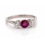 A diamond and ruby three stone ring, central round old Swiss cut ruby weighing approx  0.50ct, two