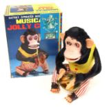 Musical Jolly Chimp: A boxed, battery operated, tin and plush, Musical Jolly Chimp, Made by C.K,