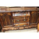 An early 19th century reproduction Dutch Dresser with crow's ball and claw feet and brass ring