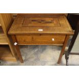 An early 20th Century oak inlaid sewing box with lift up lid