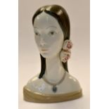 A Lladro "Daisa" head and shoulders study of a lady with with roses in her hair and with a pendant.