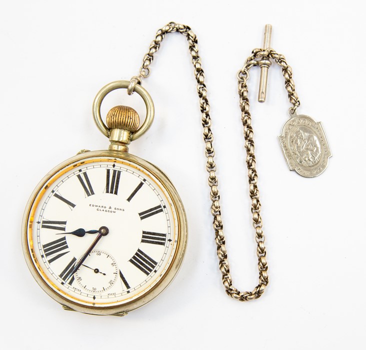 An Edward & Sons of Glasgow Goliath pocket watch, white metal with white enamel dial numerals and