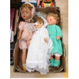 One walking doll, original clothing, and second dress together with a pair of 1960's dolls, one in