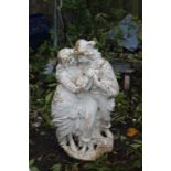 Composite garden statue of a courting couple, painted white