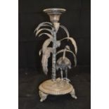 An early 20th Century metal candlestick holder with an emu and palm trees