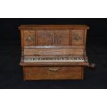 Miniature musical piano and wooden upright piano with metal pierced disc at the back, hand cranked