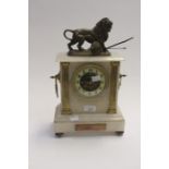 A circa 20th Century onyx mantle clock with bronzed lion on the tip, Arabic numerals with pendulum
