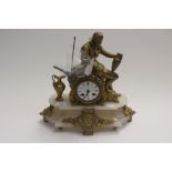 A late 19th Century French mantle clock with male bronze figure, sat above dial, onyx base, key
