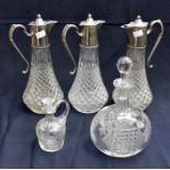 A collection of decanters and claret jugs, cut glass