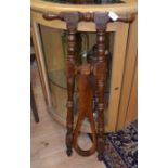 An unusual floor standing folding boot pull with grip handles, mahogany, late 19th Century, turned