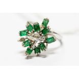 An 18k white gold diamond and emerald dress ring