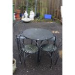 A metal outdoor garden dining set, including table and four chairs.