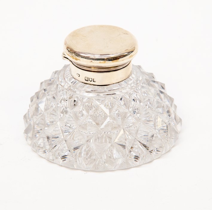 A cut glass ink bottle with silver top, London 1902, 11cm diam