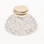 A cut glass ink bottle with silver top, London 1902, 11cm diam