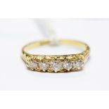 An 18ct gold and diamond five-stone ring, size Q, approx 3gms, in box