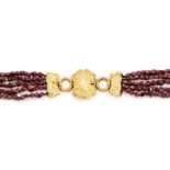 A Victorian five row garnet bead necklace, with yellow gold shield clasp, comprising small round