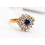 A sapphire and diamond flower head cluster ring, set to the centre with a round sapphire approx 4mm,
