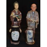 A pair of early 20th Century Japanese figures, man and woman
