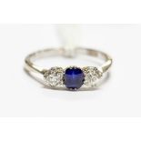 A three stone sapphire and diamond ring, the old cut diamonds approx 0.25ct each, size P, approx 3.