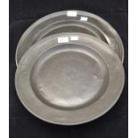 A late 17th English pewter charger the front of reeded rim stamped with pseudo-hallmarks and