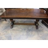 A 20th century oak rectangular carved coffee table, on a globe turned support on rectangular feet.