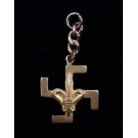 An 18ct gold pendant, Fleur De Lys and Swastika symbol, total gross weight approx. 3.5gms