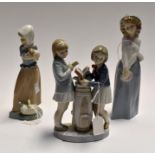 A Lladro figure of two girl golfers along with two Nao figures