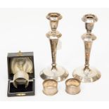 A pair of silver candlesticks, Birmingham marks rubbed probably 1910 along with napkin rings