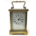 A Brass Carriage Clock with white enamel dial and Roman numerals. London makers mark. Height