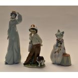 Lladro: group of boy with puppy and a snail no 5738 and 2 clowns no's 8045 and A15. 3 items