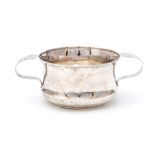A George V silver porringer / loving cup, plain ogee body with shaped C-scroll handles, by