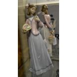 A pair of Lladro figurines of young flower girls. 2 items