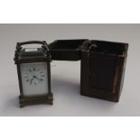 A late 19th Century brass carriage clock in travel case