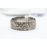 A platinum ring, engraved with flowers, size N1/2, total gross weight approx 6.9gms