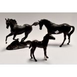 Two Royal Doulton black horses, along with Black Beauty by the Franklin Mint