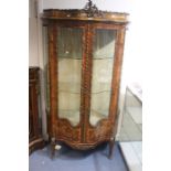 A Louis XV revival kingwood vitrine ormolu display cabinet, serpentine shape, ormolu decoration on